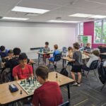 Children playing chess at summer camps.