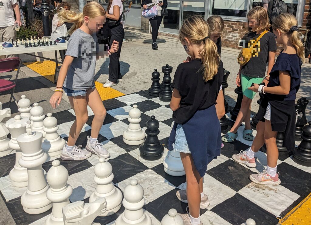 Kids playing giant chess outdoors. Credit: Heidi Gay