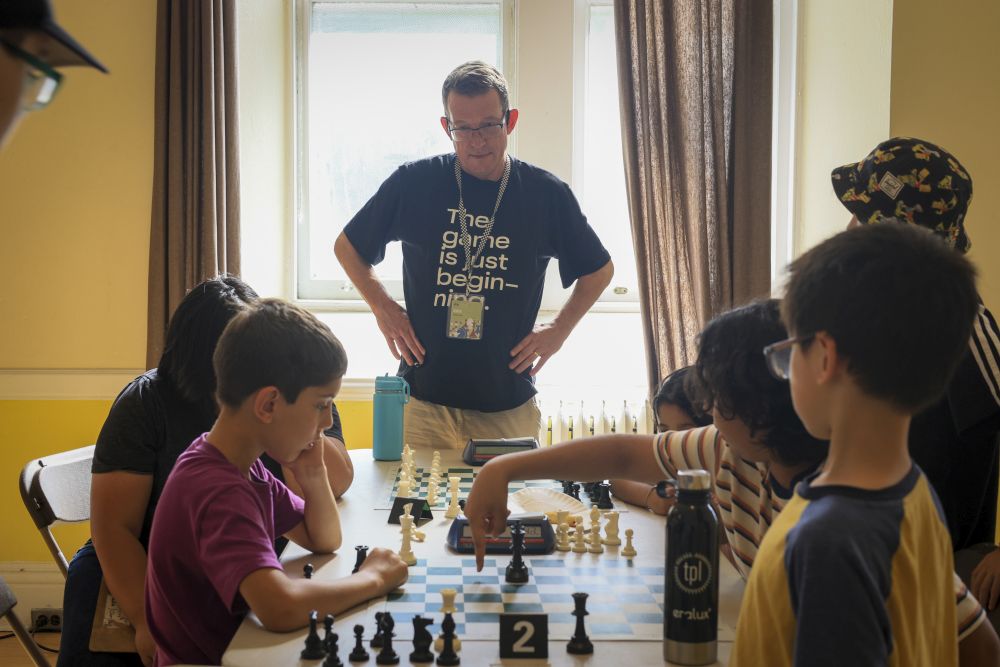 Instructor supervising chess match