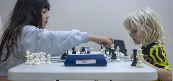 Two girls play chess at a CIC PA Day camp