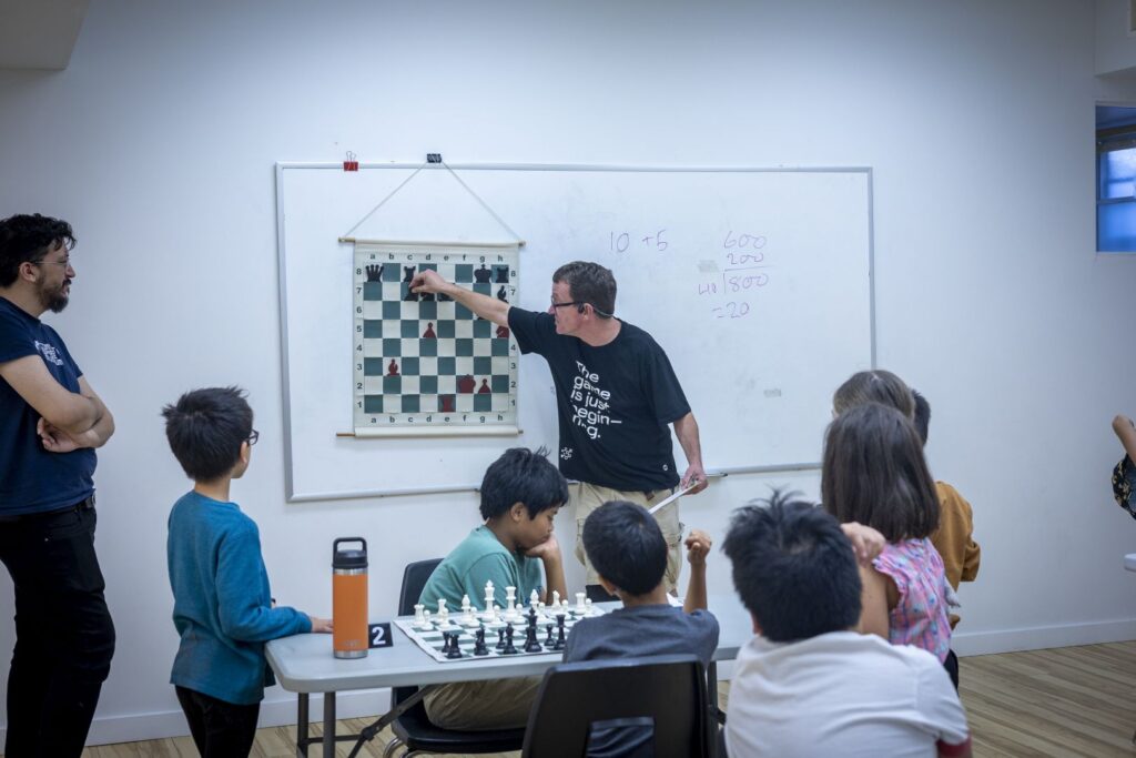 Instructor shows puzzle on board to students