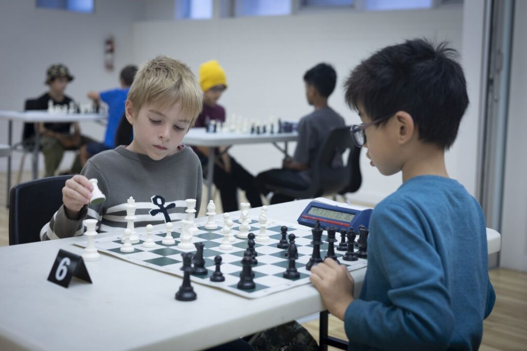 Two boys play chess